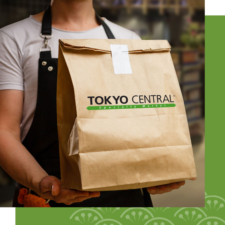 Man holding paper bag with caption Save your time. Get Japanese food and groceries delivered same day